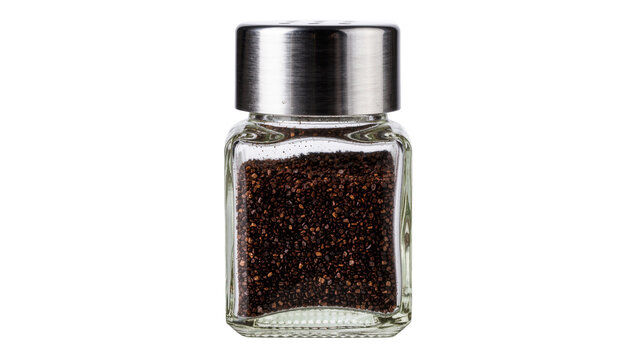 Square glass pepper shaker with metal lid filled with ground black pepper, isolated on transparent background