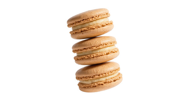 Stack of three light brown macarons with cream filling, isolated on transparent background