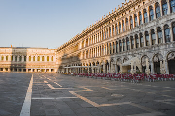 Wide view of historic Venetian architecture and the open square of Piazza San Marco in Venice, Italy, captured in soft evening light. © Anastasia