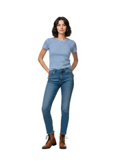 Obraz premium Young woman with dark wavy hair, wearing a striped t-shirt, denim jeans, and leather boots, standing confidently in a bright minimalist white studio, natural everyday style concept