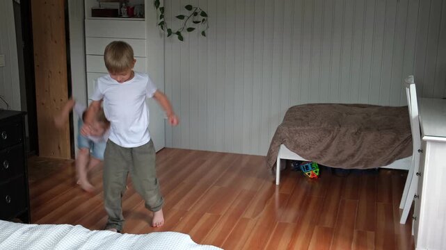 Happy active siblings exercising dancing together. Cute brother and sister jumping, doing fun sports routine. Fighting sedentary lifestyle in kids. Children physical health, energy wellness concept.