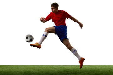 Airborne footballer meeting ball with extended attacking leg. Concept of aerial technique, volley practice, coordination and high impact soccer action. © master1305