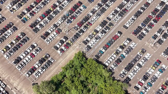 Aerial view of rows of new cars parked at a large manufacturing facility in India.
