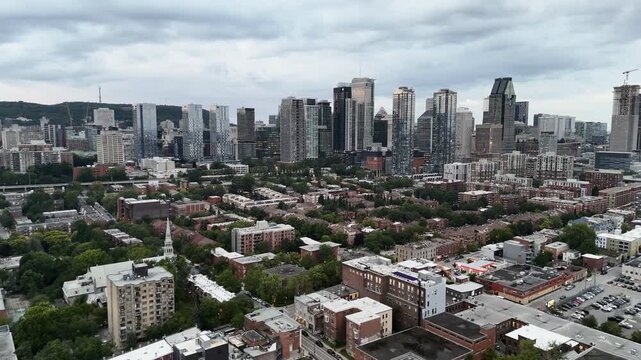 Drone view of single-storey buildings between the Lachine channel and downtown Montreal skyscrapers Quebec, Canada