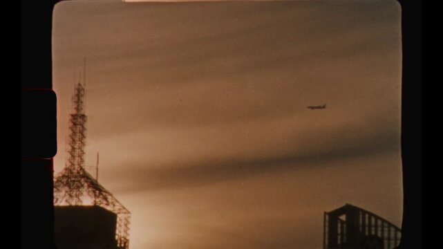 An airplane flies over the Shanghai skyline at sunset, captured on vintage Super 8mm film