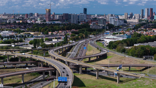 Aerial view of the Westvliet highway intersection with multi-level roads and the urban skyline of Den Haag in the background, Den Haag, Zuid-Holland, Netherlands.
