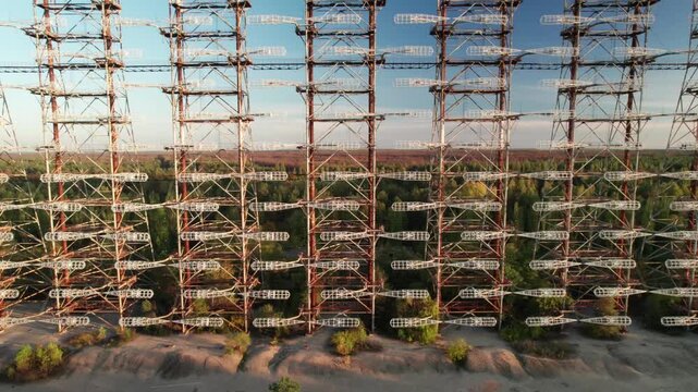 Aerial view of Duga 1 Receiver radar array with massive steel structure and antenna elements rising above the surrounding forest in Chernobyl, Kyiv Oblast, Ukraine.