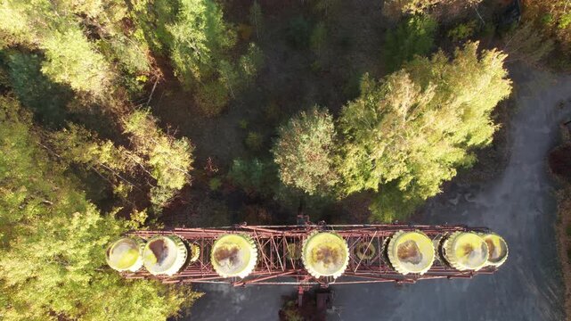 Aerial view of the iconic abandoned Ferris wheel in Pripyat, surrounded by overgrown trees, highlighting the decay of the Chernobyl exclusion zone in Pripyat, Kyiv Oblast, Ukraine.