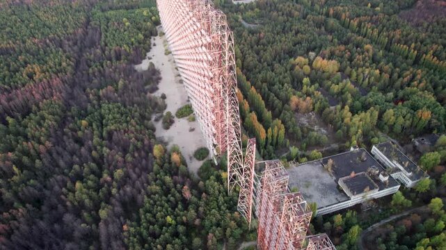 Aerial view of the massive Duga 1 Receiver radar array surrounded by dense forest in Chernobyl, Kyiv Oblast, Ukraine.