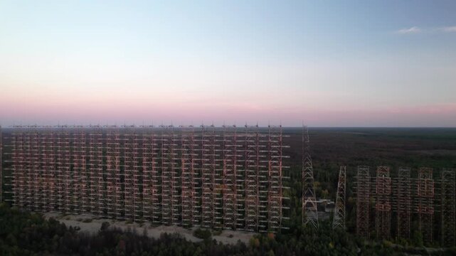 Aerial view of the massive Duga 1 Receiver radar array rising above the forest canopy in Chernobyl, Kyiv Oblast, Ukraine.