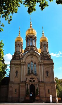 Wiesbaden, Hesse, Germany &ndash; Russian Orthodox Church of Saint Elizabeth with distinctive golden onion domes under blue sky.