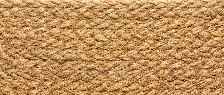 Braided natural jute fiber strap texture. Close up of woven rope handle pattern