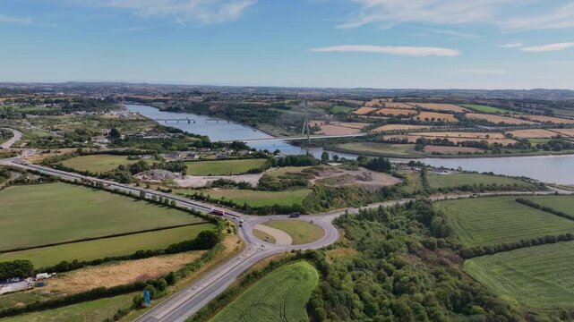 Amazing aerial Ireland drone flying over exit M9 with overview of Waterford City and transport system over The Thomas Francis Meagher bridge spanning the River Suir