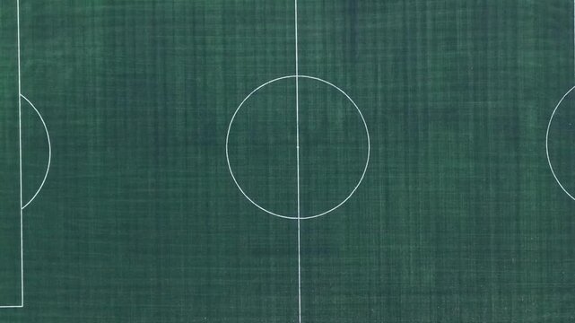 Aerial Overhead Close Up View of Soccer Pitch Center Circle and Midfield Line, Green Synthetic Turf Texture Field in Corfu Greece