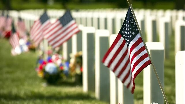 white veteran headstones with a small American flag dominating the foreground, repeating grave markers, patriotic banners and memorial flowers fading gradually into the distance, Memorial Day cemetery