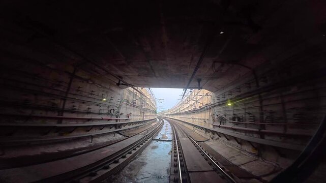 Title: The view from the last coach of a driverless metro train and a video created by reversing the footage.
