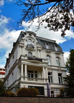 Wiesbaden, Hesse, Germany &ndash; Elegant historic villa with ornate facade, curved mansard roof, balconies and decorative architectural details.