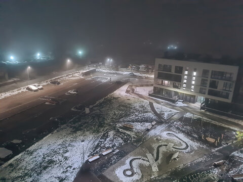 Winter night view of modern residential complex courtyard with street lights in Lviv, Ukraine