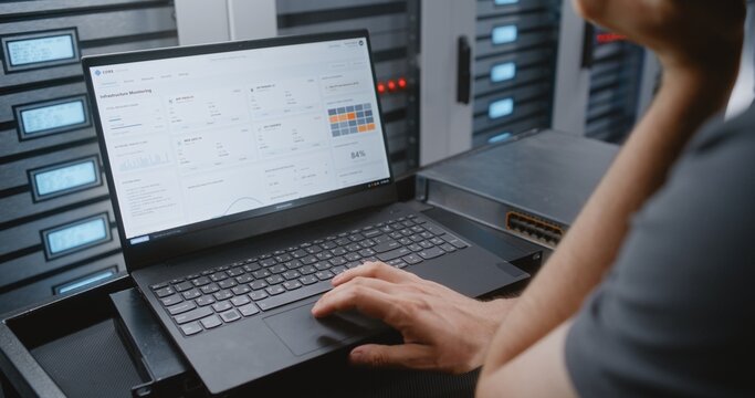 Male IT Specialist Responds To Cyber Attack Alert Using Linux Command Line, Reviewing Telemetry and Performing Emergency Recovery Actions During Critical Network Security Incident Within Data Center.
