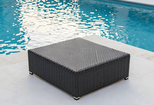 Luxury vacation and summer lifestyle, modern wicker coffee table on a poolside patio with blue water background for outdoor relaxation and home decor