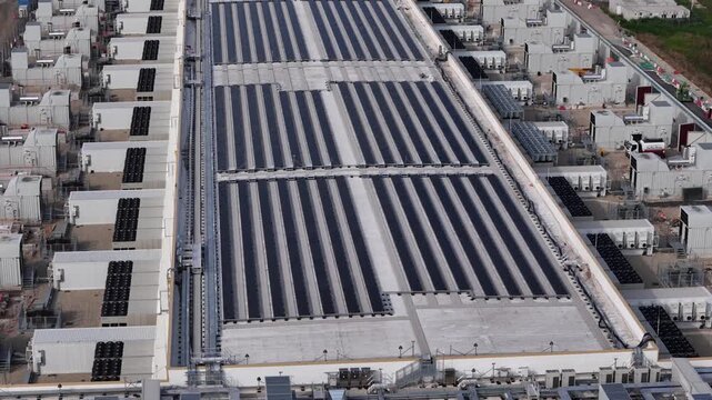 Aerial view of the modern data center facility featuring rows of cooling units and technical infrastructure on the roof in Noviglio, Lombardy, Italy.