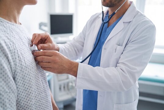 Doctor Examining Patient with Stethoscope in Hospital