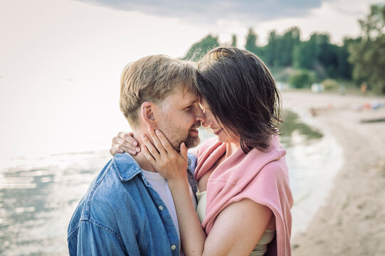 A loving couple embraces on the beach during a summer vacation
