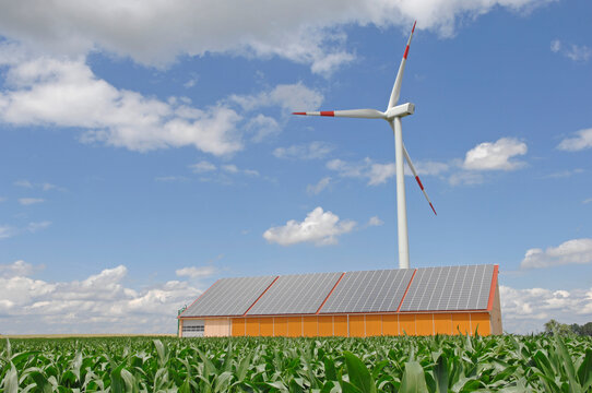 Germany, Baden-W�rttemberg, Merklingen, Solar panels and wind turbine on roof