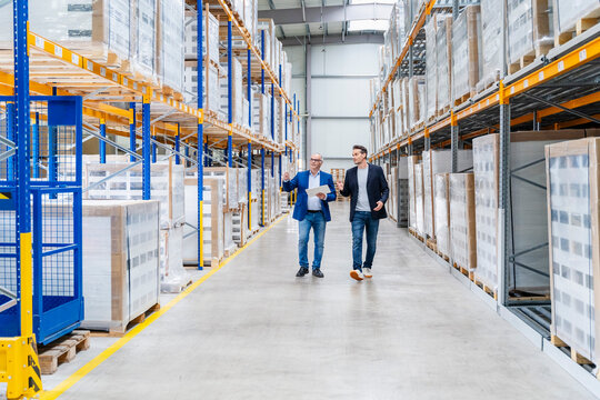 Manager and supervisor inspect the warehouse inventory