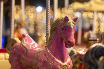 Pink Carousel Horse Against Golden Bokeh Lights © Emanuel