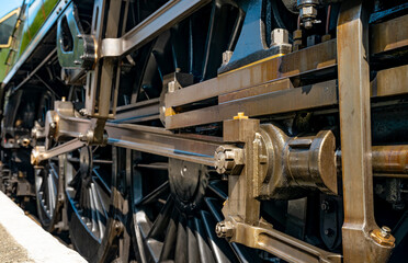 Close-up of the driving wheels, connecting rods and mechanical details of a modern-built steam locomotive at Grosmont, North Yorkshire, England. © ON-Photography