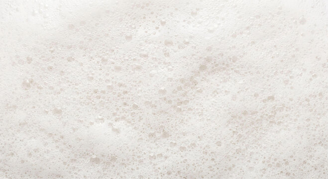 Close-up macro view of light beige foam with many small bubbles