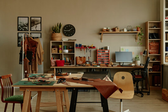 Empty leather craft workshop with tools and materials on table