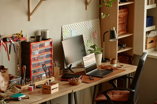 The modern craft workshop features a desk with a computer and tools