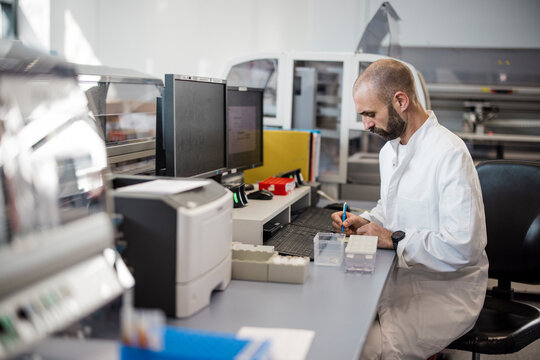 Male scientist works on a circuit board in a high tech laboratory