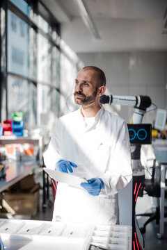 Scientist holds a tablet in a modern research laboratory