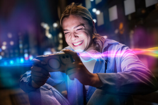 Smiling woman holds mobile device with glowing AI light in city
