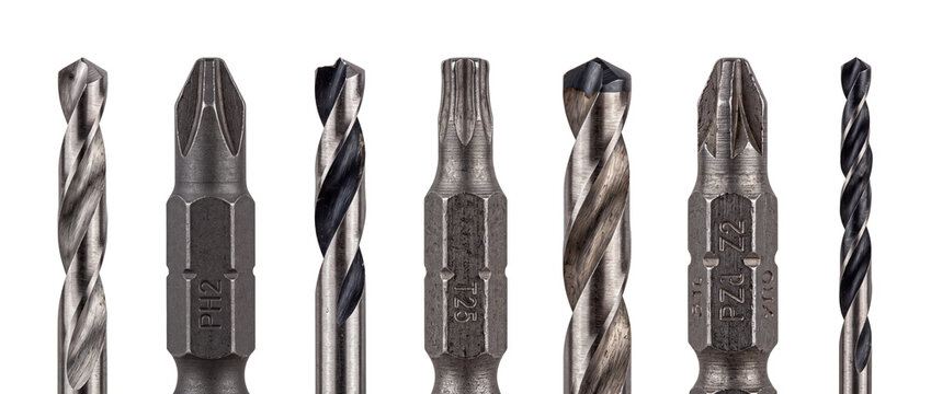 Drill bits and screwdriver bits set lined up on black background, featuring metal phillips, torx, pozidriv, and twist drill attachments for professional hardware, construction, and repair tools.