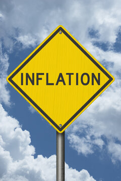 Inflation yellow warning sign with sky for price increases