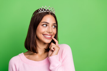Young woman wearing a tiara pink sweater smiling against green background in fashionable lifestyle stock image © deagreez
