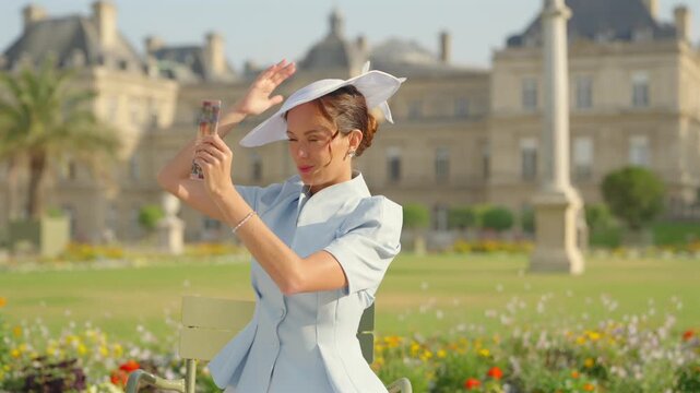 Woman taking a smartphone selfie in Luxembourg Gardens, Paris