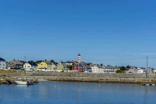 Alnes village harbor with a lighthouse and colorful houses