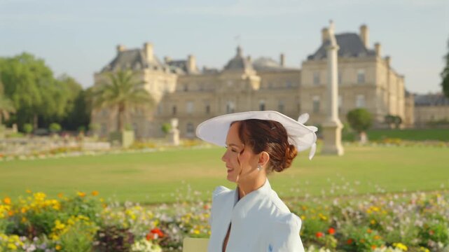 Pullback view of woman seated at Luxembourg Gardens in Paris
