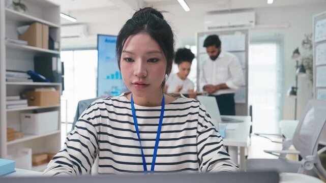 Asian Female business working on a laptop at office