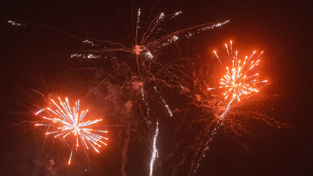 Bright red fireworks exploding in the night sky