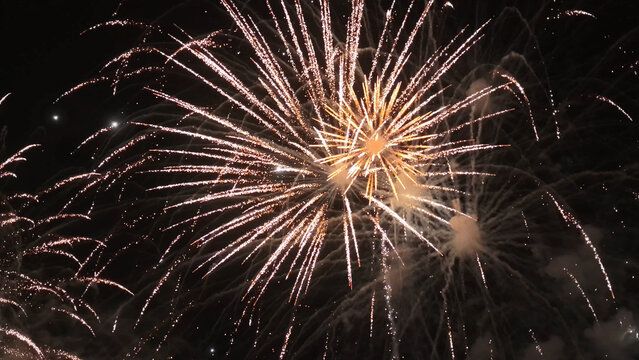 Sparklers Erupting Behind Fence on Dark Night