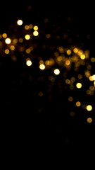 Golden bokeh lights on black background, festive celebration backdrop © MariiaDemchenko