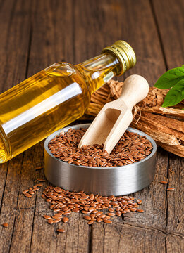 Flax Seeds with Wooden Scoop and Flaxseed Oil