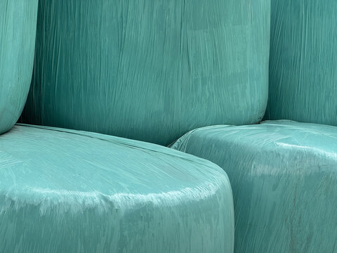 Close-Up Of Turquoise Hay Bales Wrapped In Plastic Near K&ouml;nigsleiten Austria During Summer In Tirol Region For Agricultural Concepts
