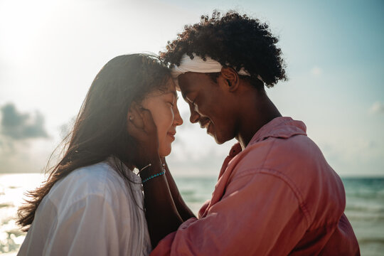 Pure happiness. A young diverse, multiethnic couple enjoys every moment of their tropical getaway